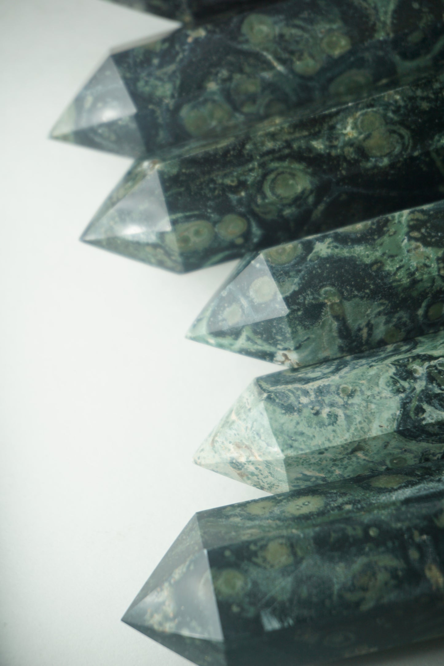 Kambaba Jasper: An intriguing and visually captivating crystal, is cherished for its deep green color and distinct swirling patterns reminiscent of lush landscapes.