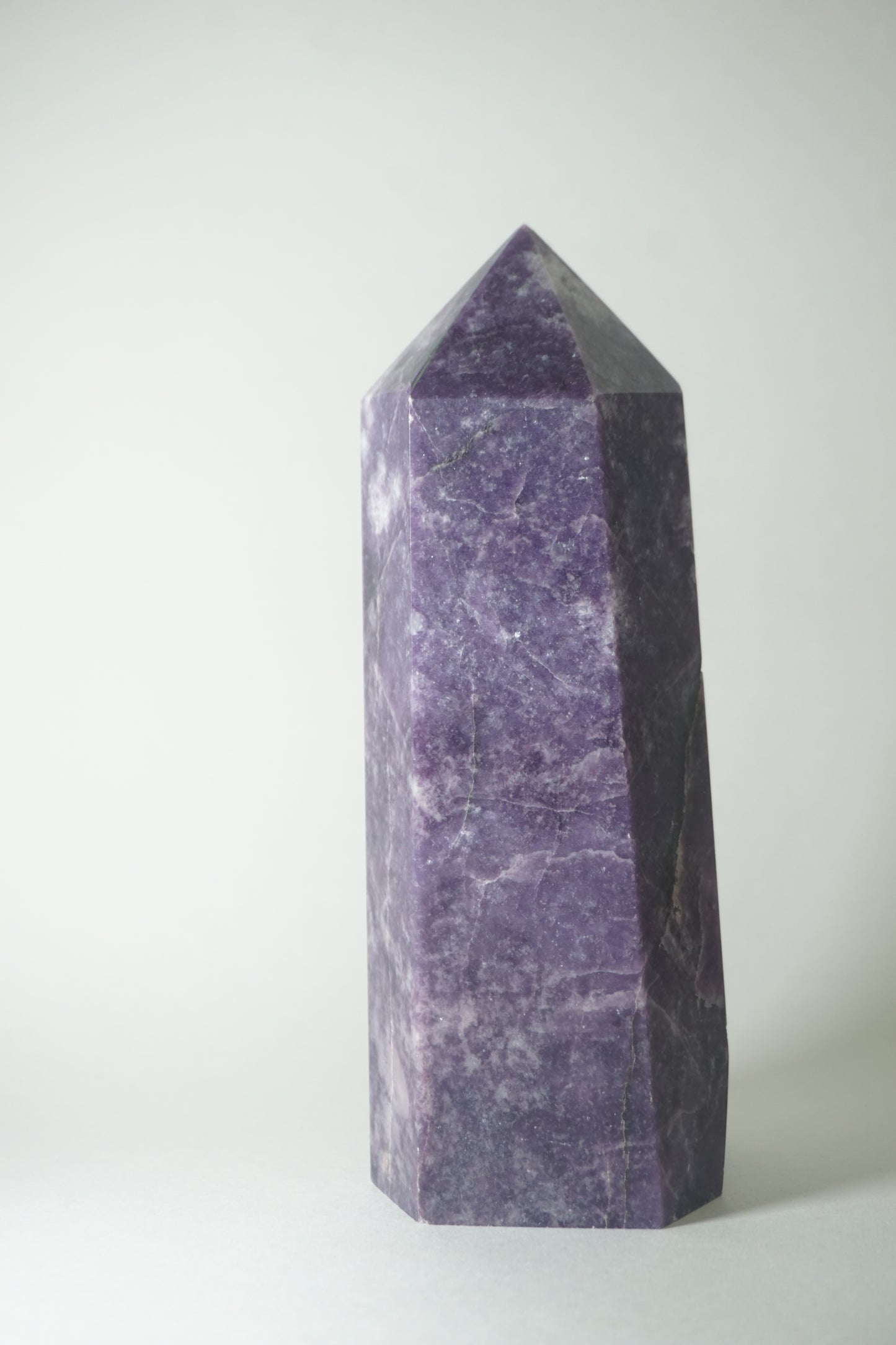 Lepidolite: A serene and calming crystal, is prized for its soft shades of purple and its potent connection to emotional healing and balance. With its association to the Heart, Third Eye, and Crown chakras, Lepidolite promotes inner peace, emotional release, and spiritual insight.