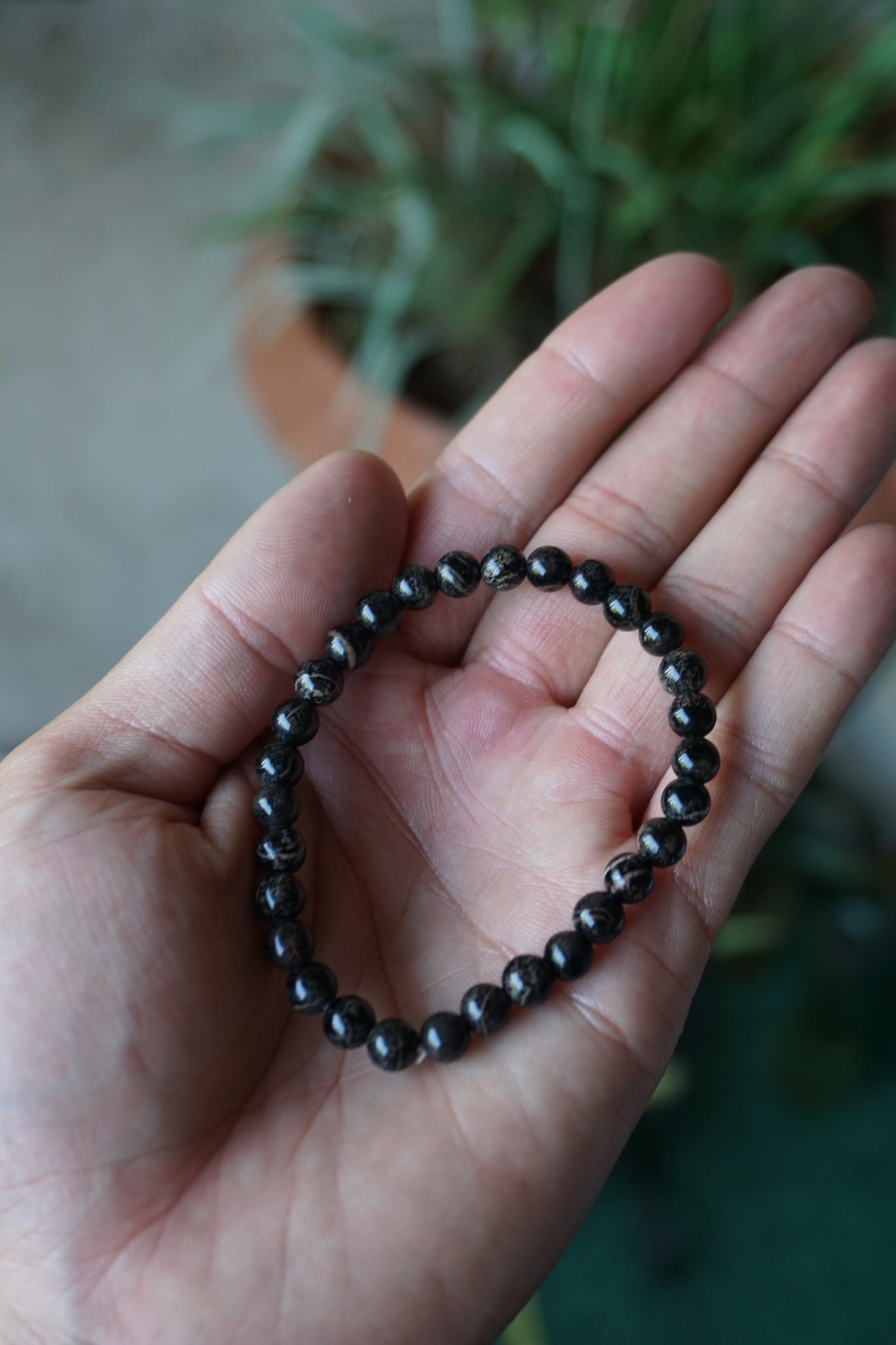 Snowflake Obsidian: A unique and mesmerizing crystal, is cherished for its black base color adorned with delicate white "snowflake" patterns. With its grounding and protective energy, Snowflake Obsidian is believed to promote inner balance, emotional healing, and a sense of security.