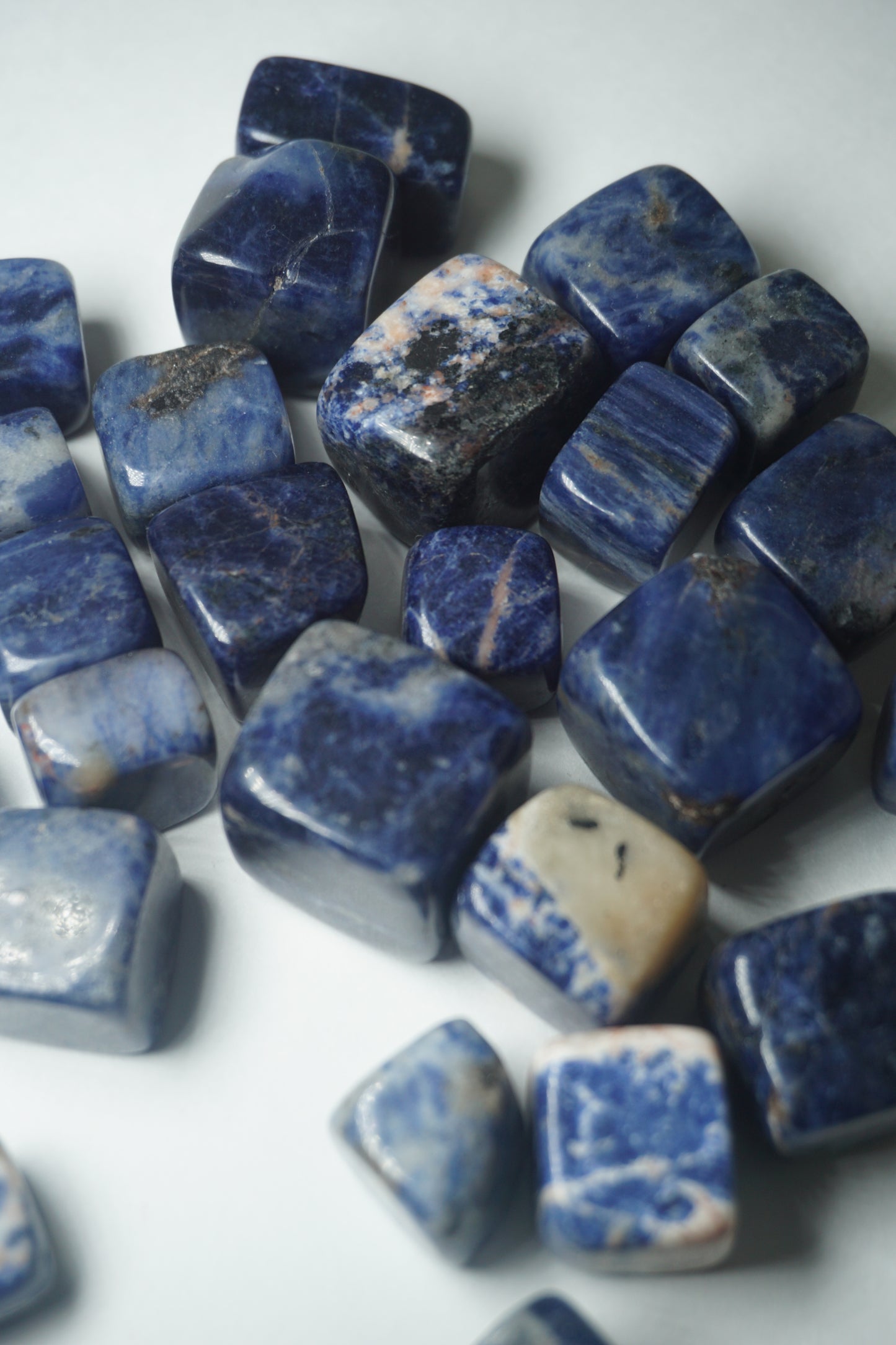 Sodalite: A captivating deep blue crystal mottled with white veins, is esteemed for its harmonizing properties that bridge the gap between logic and intuition. With its serene and calming energy, Sodalite is believed to enhance mental clarity, promoting rational thought and aiding in effective communication.