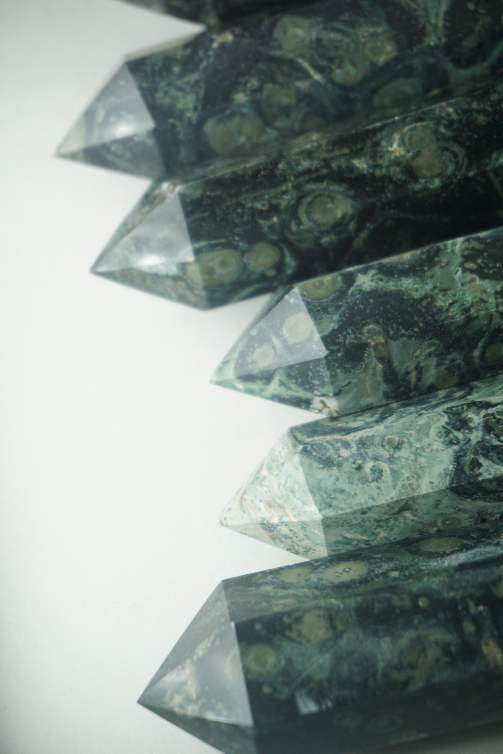 Kambaba Jasper: An intriguing and visually captivating crystal, is cherished for its deep green color and distinct swirling patterns reminiscent of lush landscapes.