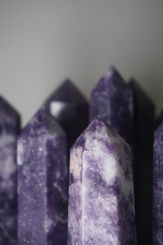 Lepidolite: A serene and calming crystal, is prized for its soft shades of purple and its potent connection to emotional healing and balance. With its association to the Heart, Third Eye, and Crown chakras, Lepidolite promotes inner peace, emotional release, and spiritual insight.