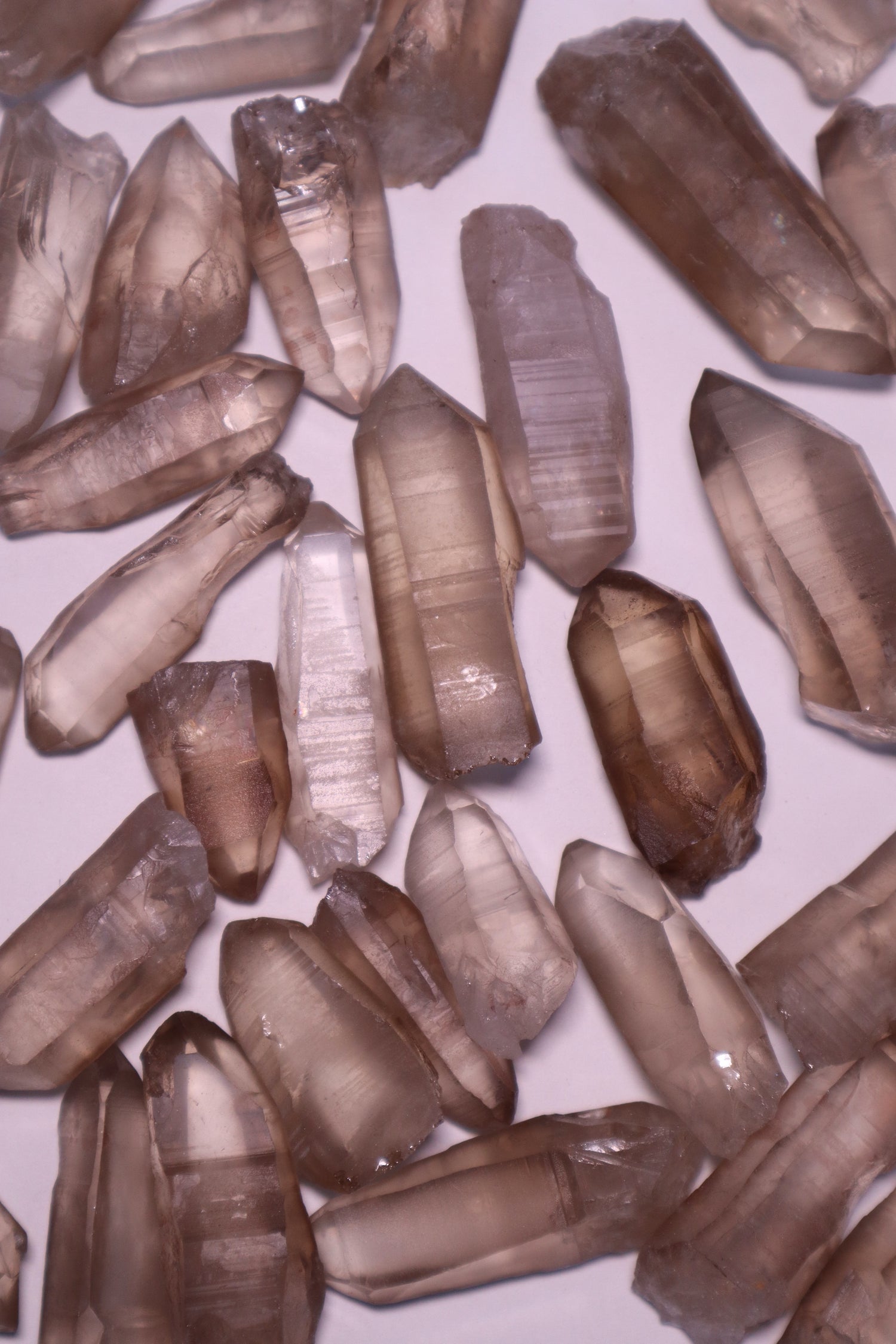 Smokey Lemurian: A unique variation of the renowned Lemurian Quartz, possess a rich smoky hue that infuses them with grounding and protective energies.