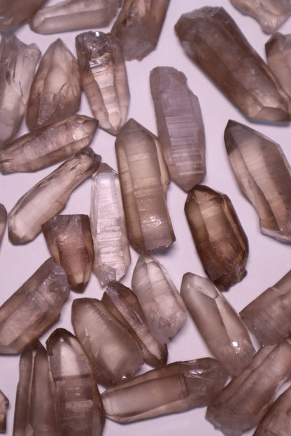 Smokey Lemurian: A unique variation of the renowned Lemurian Quartz, possess a rich smoky hue that infuses them with grounding and protective energies.