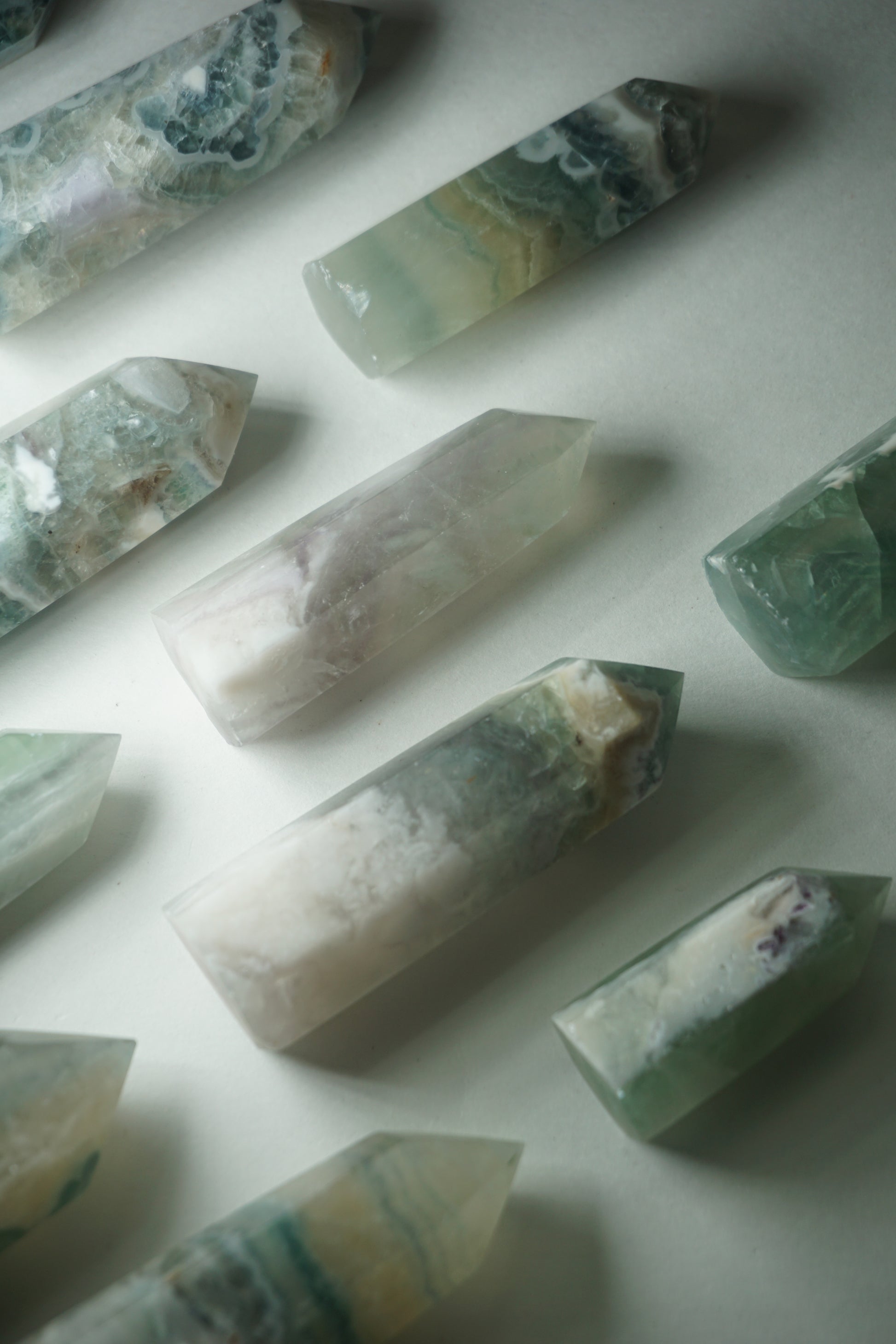 Feather Fluorite: A striking and captivating crystal, stands out for its intricate and feather-like patterns that dance across its surface. This unique crystal combines the gentle energy of fluorite with its mesmerizing visual appeal.