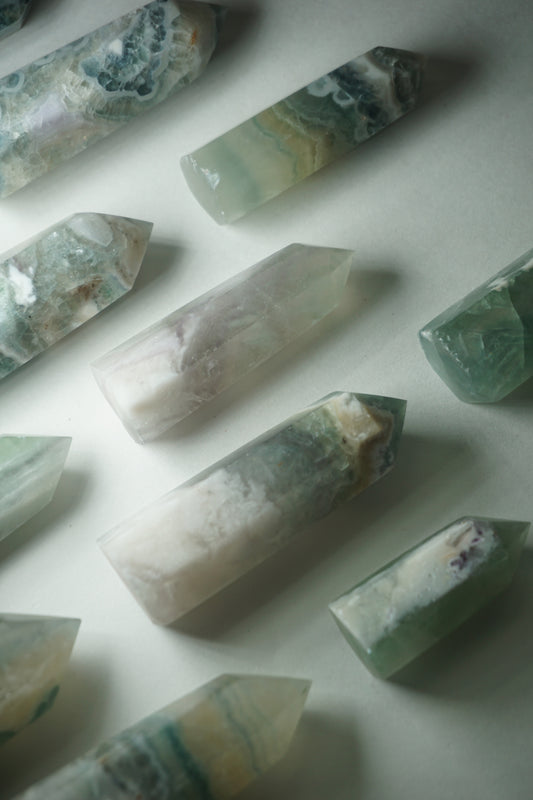 Feather Fluorite: A striking and captivating crystal, stands out for its intricate and feather-like patterns that dance across its surface. This unique crystal combines the gentle energy of fluorite with its mesmerizing visual appeal.