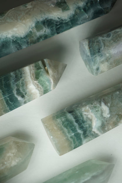 Feather Fluorite: A striking and captivating crystal, stands out for its intricate and feather-like patterns that dance across its surface. This unique crystal combines the gentle energy of fluorite with its mesmerizing visual appeal.