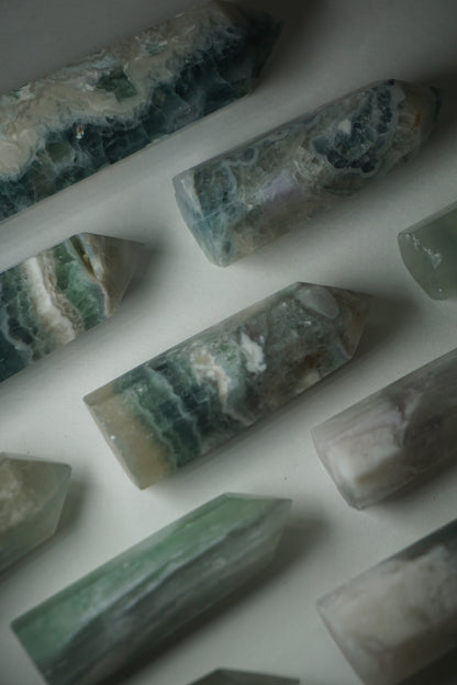 Feather Fluorite: A striking and captivating crystal, stands out for its intricate and feather-like patterns that dance across its surface. This unique crystal combines the gentle energy of fluorite with its mesmerizing visual appeal.