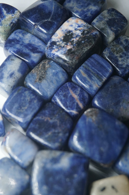 Sodalite: A captivating deep blue crystal mottled with white veins, is esteemed for its harmonizing properties that bridge the gap between logic and intuition. With its serene and calming energy, Sodalite is believed to enhance mental clarity, promoting rational thought and aiding in effective communication.