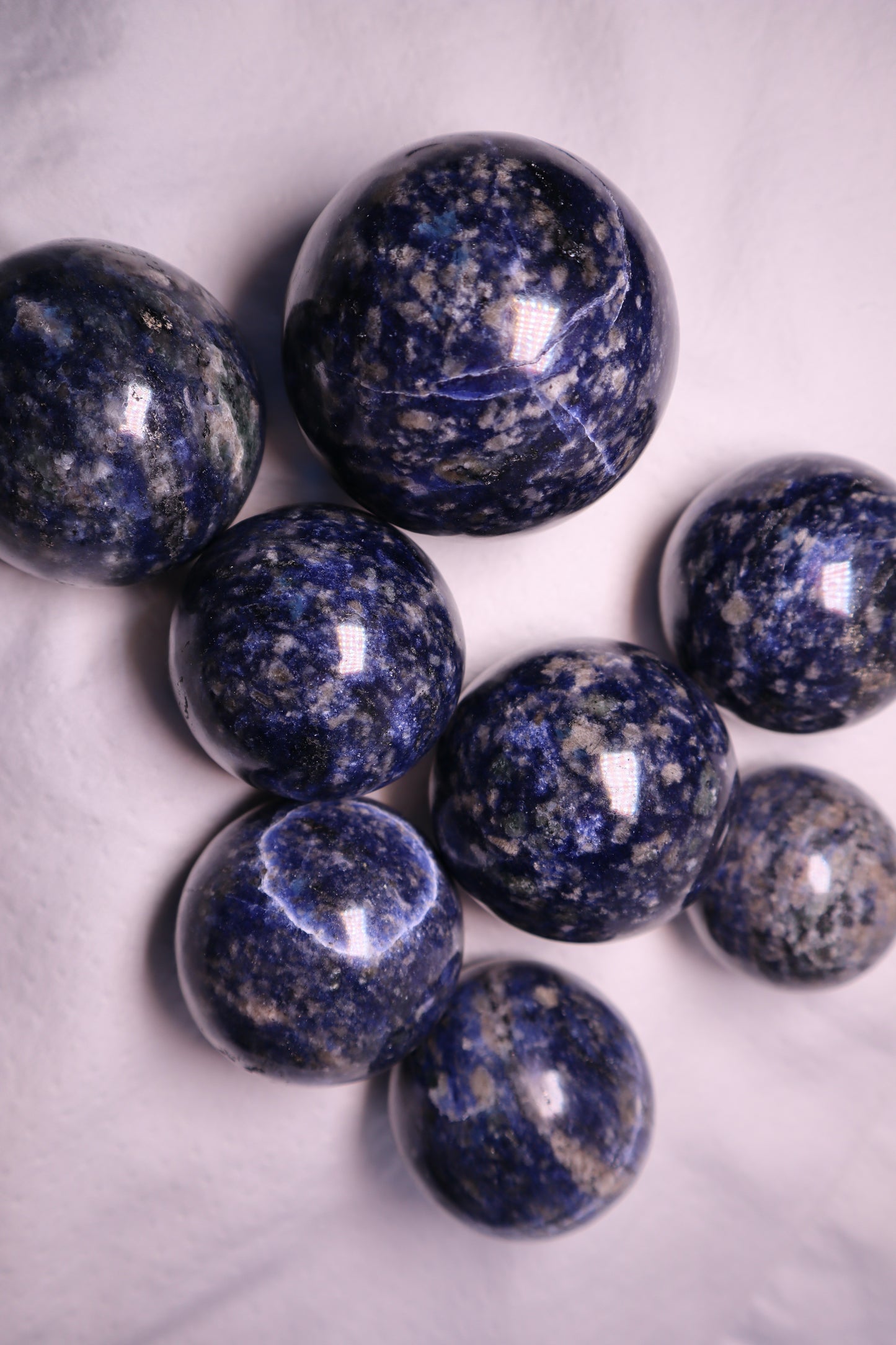 Sodalite: A captivating deep blue crystal mottled with white veins, is esteemed for its harmonizing properties that bridge the gap between logic and intuition. With its serene and calming energy, Sodalite is believed to enhance mental clarity, promoting rational thought and aiding in effective communication.